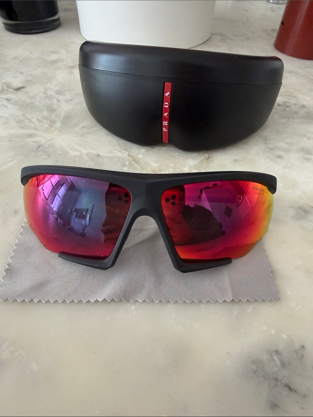 Prada Sports Sunglasses with Red Mirrored Lenses